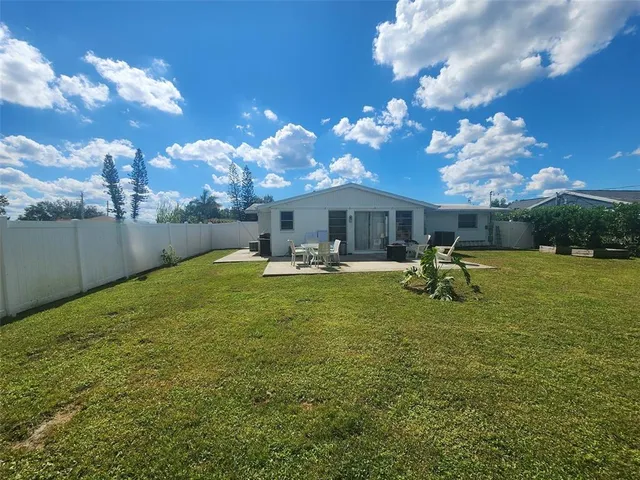 a swimming pool view with a seating space