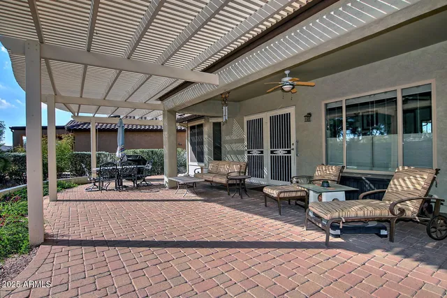 a kitchen with stainless steel appliances granite countertop a refrigerator a stove a sink and white cabinets