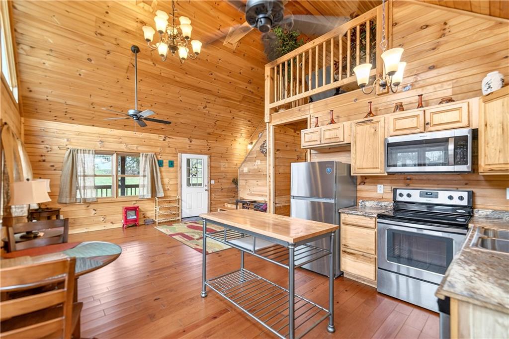 64 Memorial Drive Perryopolis, PA 15473 - Photo 11 of 44 a living room with stainless steel appliances furniture dining table and wooden floor