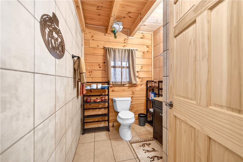 64 Memorial Drive Perryopolis, PA 15473 - Photo 14 of 44 a bathroom with a toilet and a shower curtain