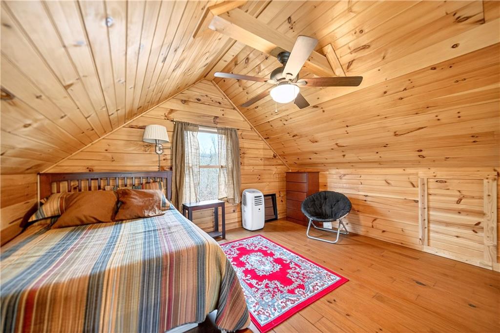 64 Memorial Drive Perryopolis, PA 15473 - Photo 25 of 44 a bedroom with a bed and wooden floor