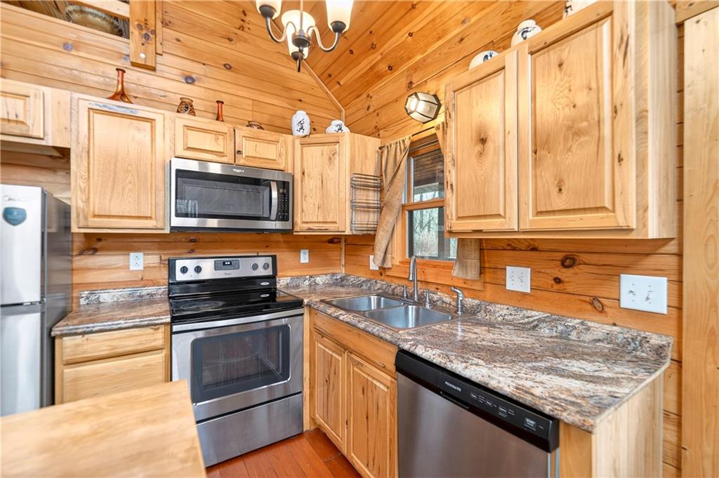 64 Memorial Drive Perryopolis, PA 15473 - Photo 10 of 44 a kitchen with stainless steel appliances granite countertop a stove a sink and a microwave