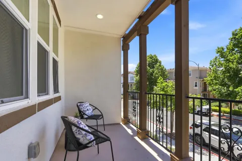 a view of a balcony with chairs