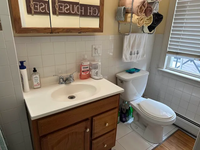 a bathroom with a sink mirror vanity and toilet