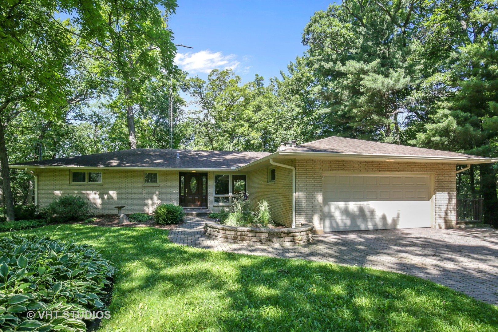 707 Hickory Road Woodstock, IL 60098 - Photo 1 of 16 a front view of a house with garden