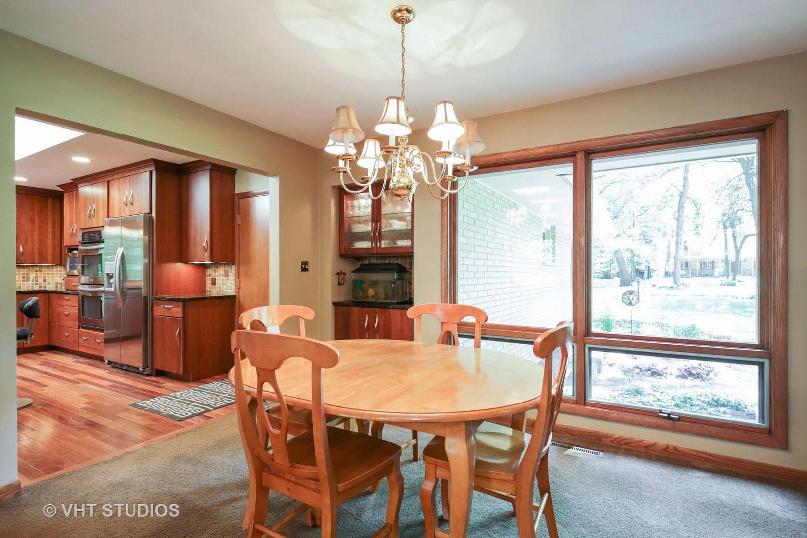 707 Hickory Road Woodstock, IL 60098 - Photo 5 of 16 a dining room with furniture a chandelier and window