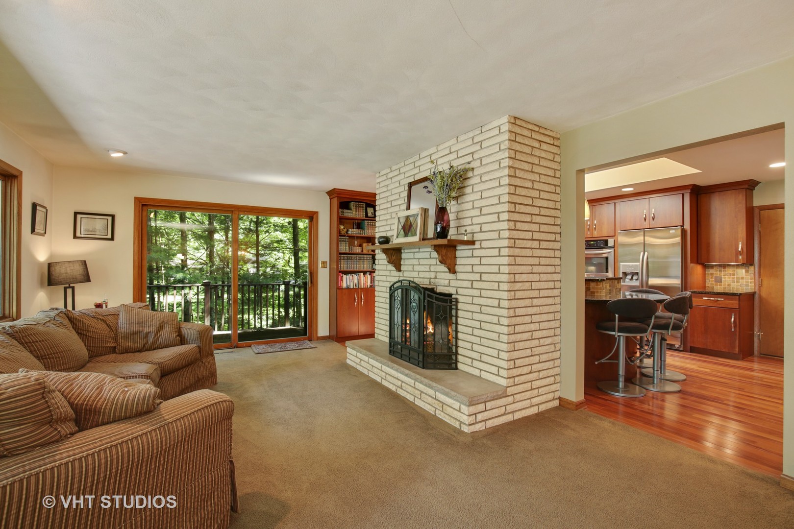 707 Hickory Road Woodstock, IL 60098 - Photo 7 of 16 a living room with furniture a fireplace and a table