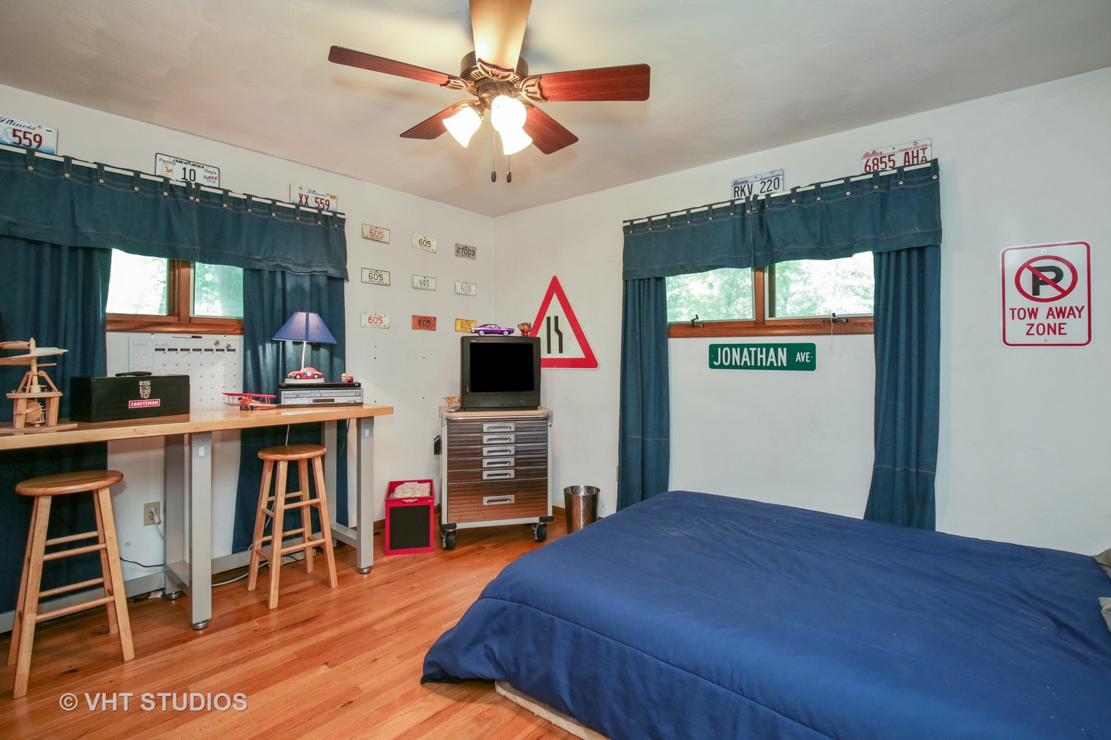 707 Hickory Road Woodstock, IL 60098 - Photo 8 of 16 a bed room with a bed and a television