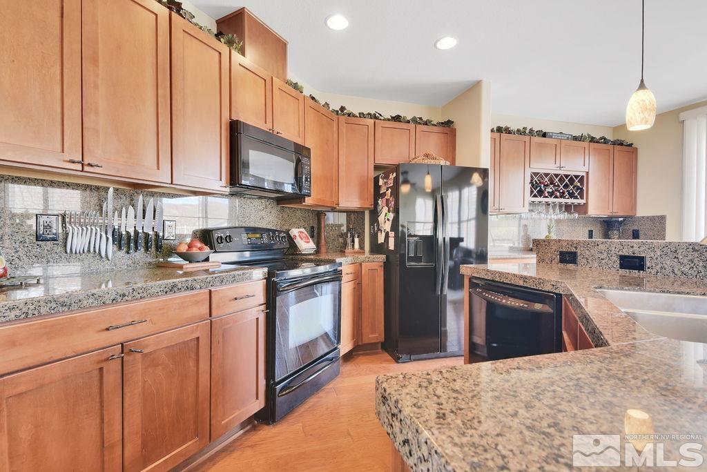 10778 Misty Meadows Drive Reno, NV 89521 - Photo 12 of 40 a kitchen with stainless steel appliances granite countertop a refrigerator sink and stove