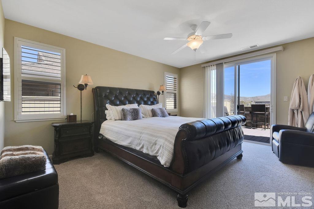 10778 Misty Meadows Drive Reno, NV 89521 - Photo 14 of 40 a bedroom with a bed couch and window