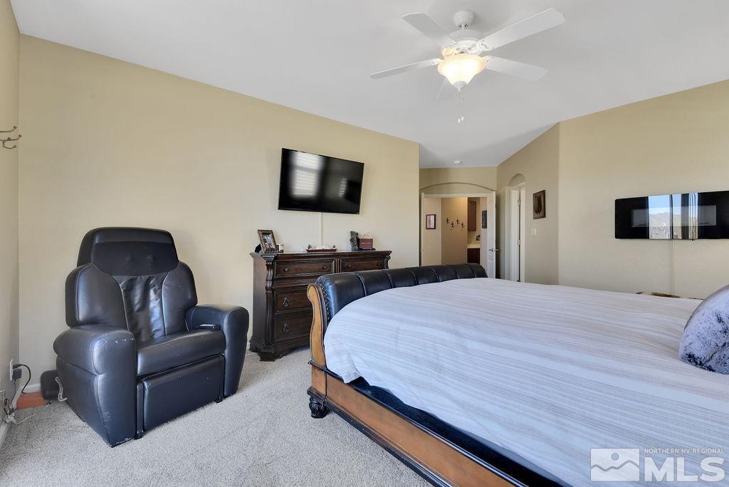 10778 Misty Meadows Drive Reno, NV 89521 - Photo 15 of 40 a bedroom with a bed and a couch