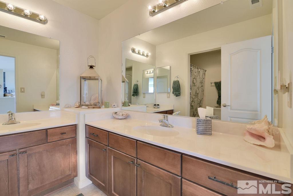 10778 Misty Meadows Drive Reno, NV 89521 - Photo 28 of 40 a bathroom with a sink and a mirror