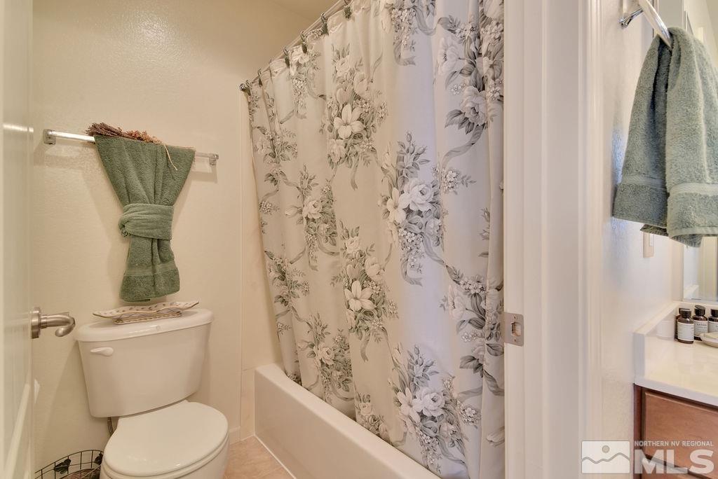 10778 Misty Meadows Drive Reno, NV 89521 - Photo 29 of 40 a white toilet sitting next to a bathroom sink