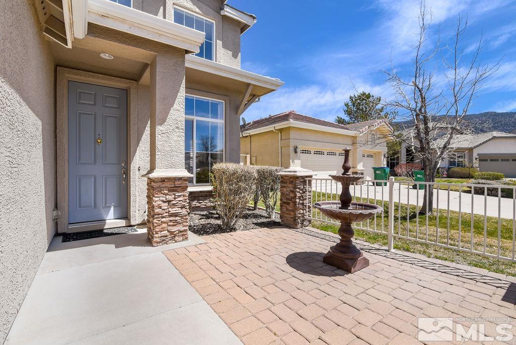 10778 Misty Meadows Drive Reno, NV 89521 - Photo 3 of 40 a view of a house with barbeque grill and wooden fence