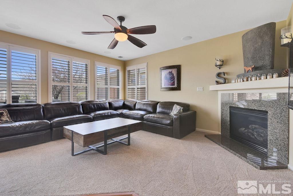 10778 Misty Meadows Drive Reno, NV 89521 - Photo 8 of 40 a living room with furniture and a fireplace