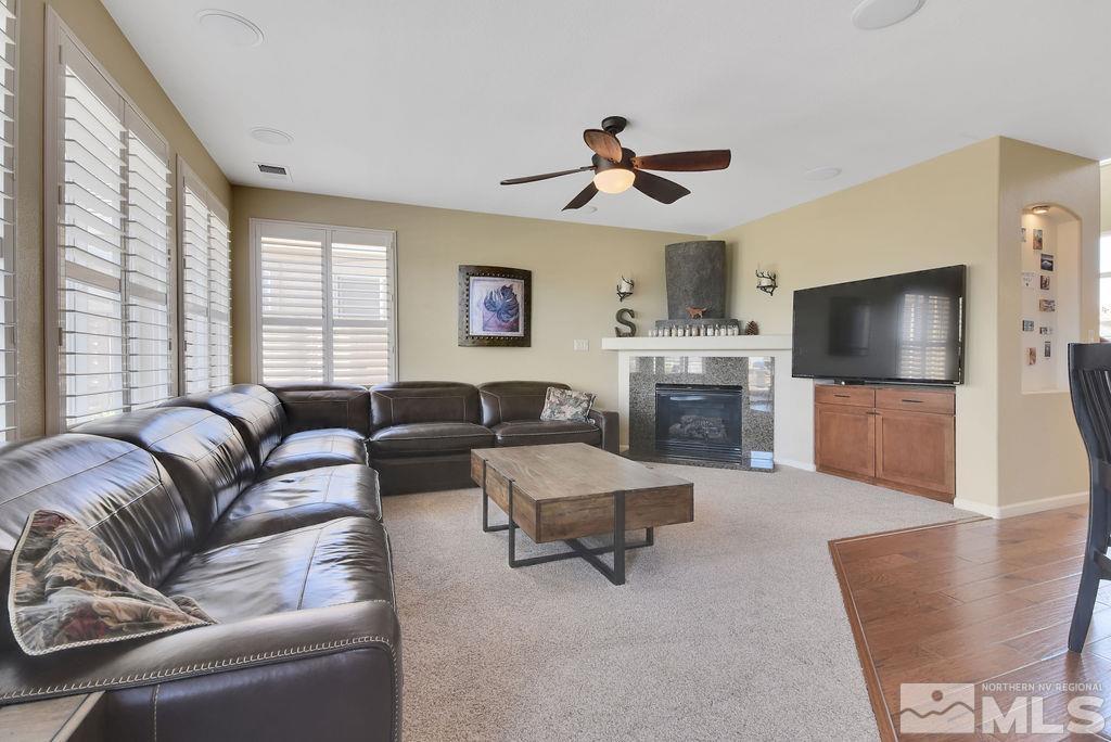 10778 Misty Meadows Drive Reno, NV 89521 - Photo 9 of 40 a living room with furniture and a flat screen tv