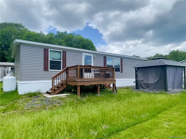 a backyard of a house with table and chairs