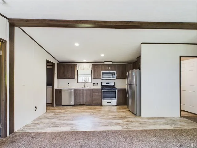 a kitchen with refrigerator and microwave
