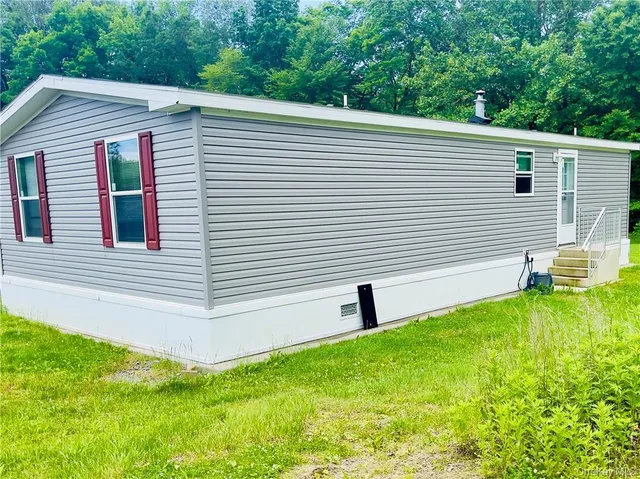 a view of a backyard with a large tree