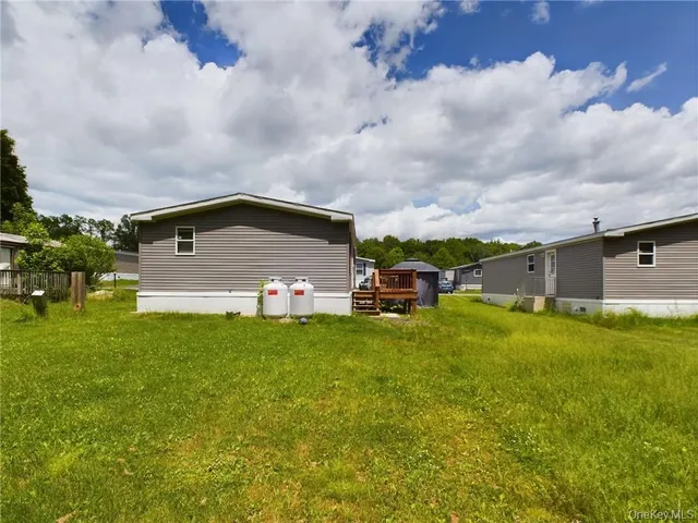 a front view of house with yard and trees