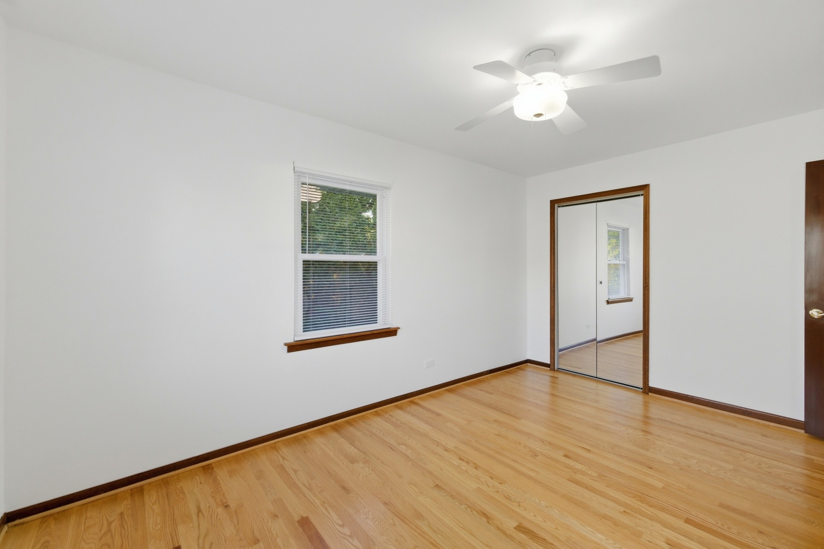 704 Springfield Drive Roselle, IL 60172 - Photo 11 of 28 wooden floor in an empty room with a window
