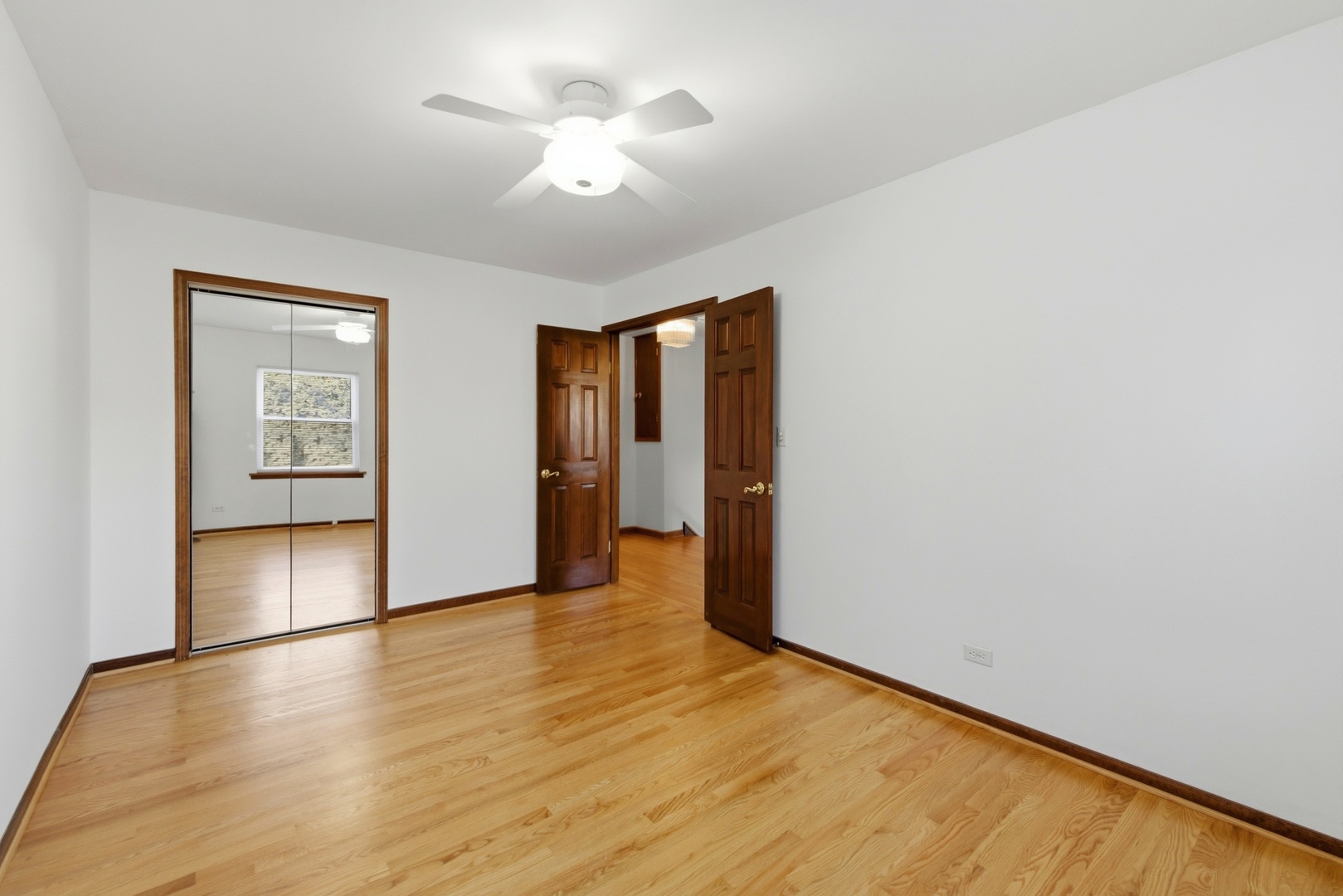 704 Springfield Drive Roselle, IL 60172 - Photo 12 of 28 an empty room with wooden floor and windows