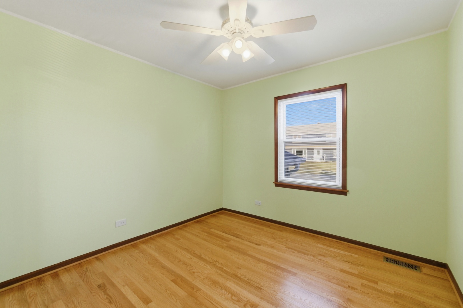 704 Springfield Drive Roselle, IL 60172 - Photo 8 of 28 an empty room with a window and a fan
