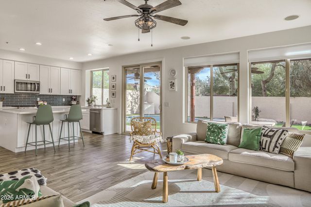 a living room with fireplace furniture and a wooden floor