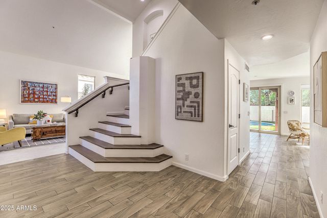 a view of entryway and hall with wooden floor