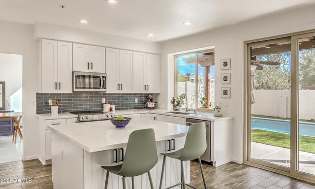 a kitchen with a stove a refrigerator and a sink