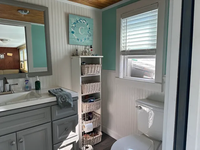 a bathroom with a toilet sink and mirror