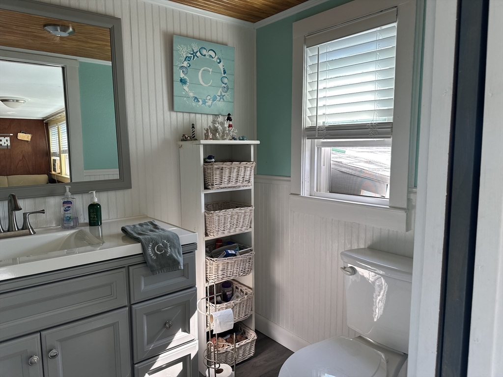 12 Waterman Street, Unit WINTER Mattapoisett, MA 02739 - Photo 11 of 19 a bathroom with a toilet sink and mirror