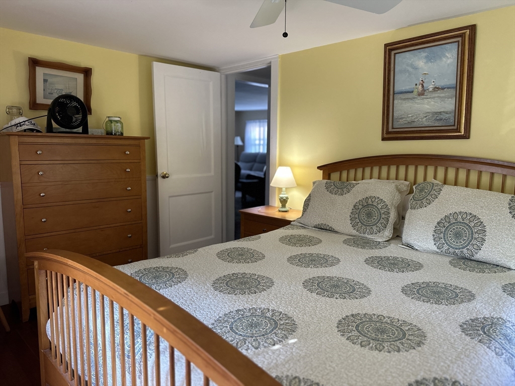 12 Waterman Street, Unit WINTER Mattapoisett, MA 02739 - Photo 12 of 19 a bedroom with a bed and dresser
