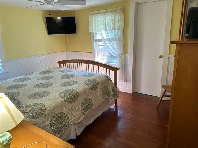 a bedroom with a bed and flat screen tv