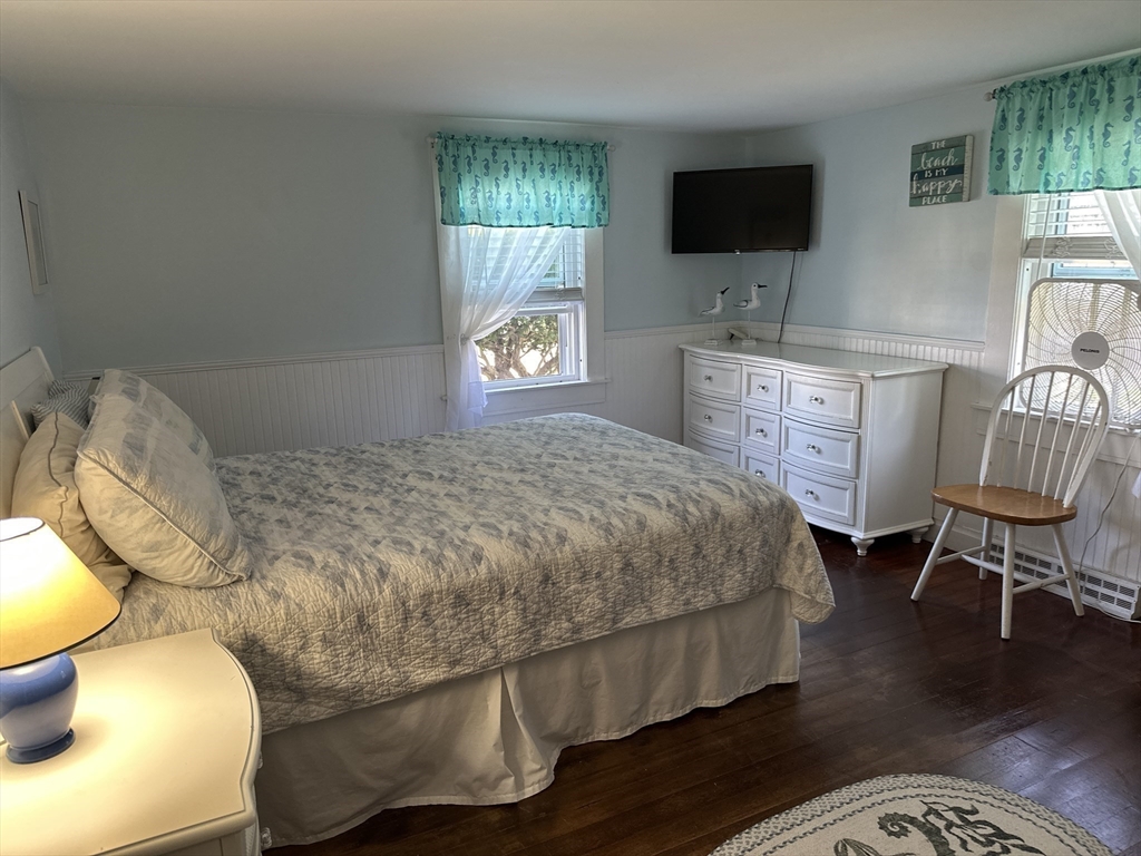 12 Waterman Street, Unit WINTER Mattapoisett, MA 02739 - Photo 14 of 19 a bedroom with a bed and flat screen tv