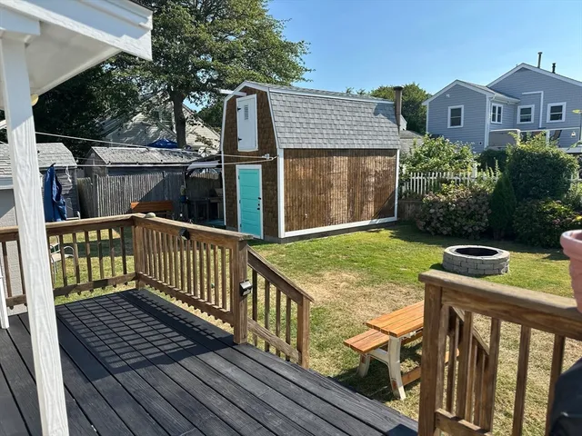 a view of a wooden house with a yard