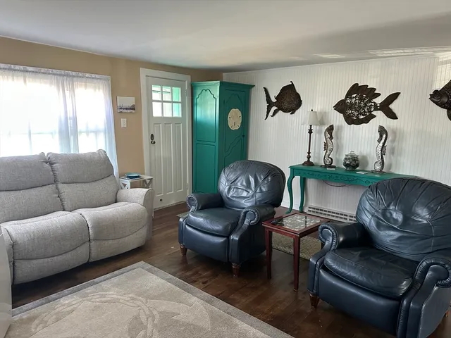 a living room with furniture rug and window