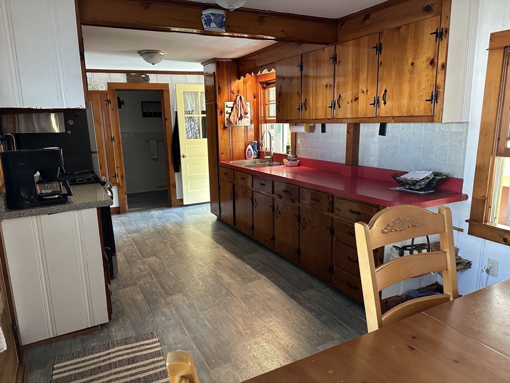 12 Waterman Street, Unit WINTER Mattapoisett, MA 02739 - Photo 7 of 19 a kitchen with stainless steel appliances granite countertop a stove a sink and a microwave