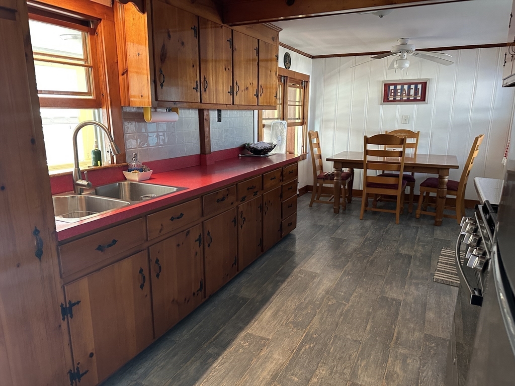 12 Waterman Street, Unit WINTER Mattapoisett, MA 02739 - Photo 8 of 19 a kitchen with stainless steel appliances granite countertop sink cabinets and wooden floor