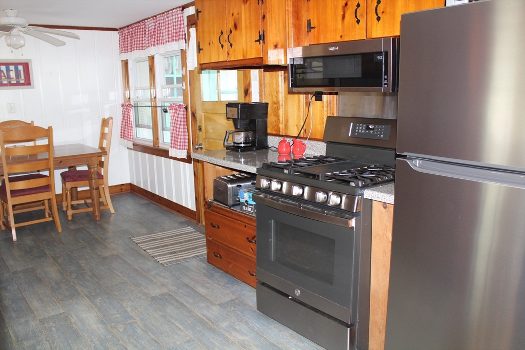 12 Waterman Street, Unit WINTER Mattapoisett, MA 02739 - Photo 9 of 19 a kitchen with stainless steel appliances a stove and a refrigerator