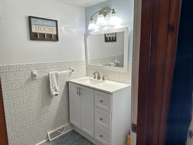 a spacious bathroom with a double vanity sink and mirror