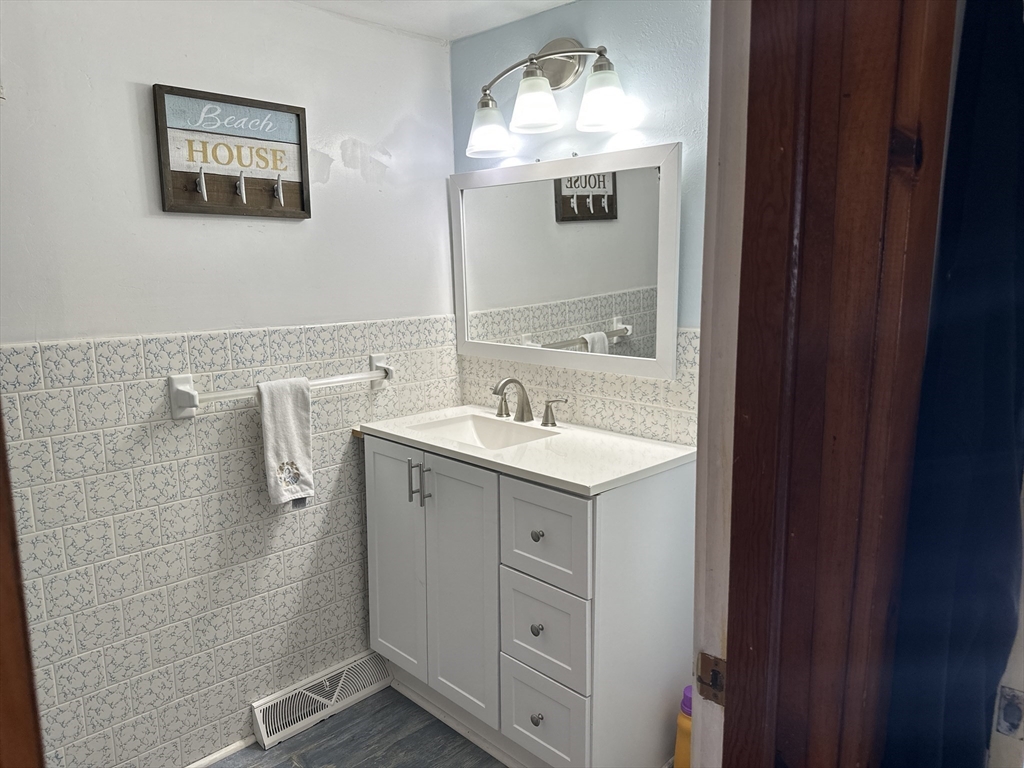 12 Waterman Street, Unit WINTER Mattapoisett, MA 02739 - Photo 10 of 19 a spacious bathroom with a double vanity sink and mirror