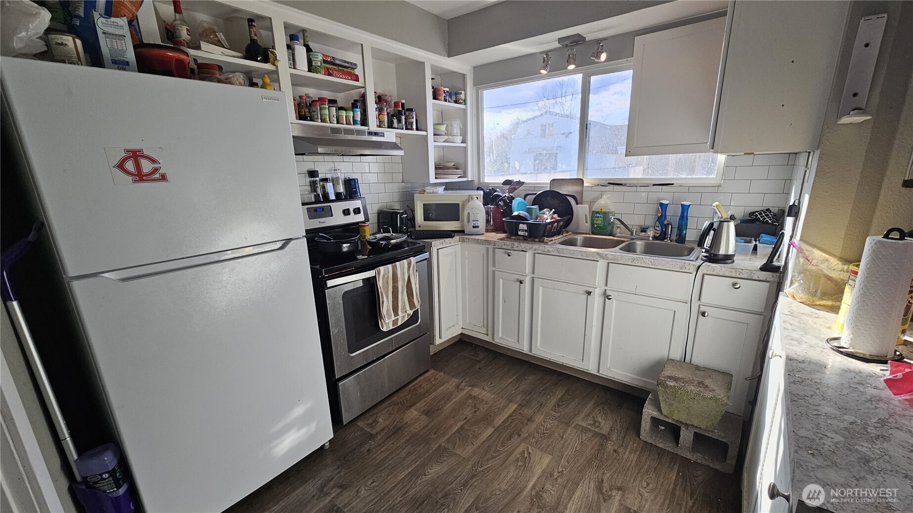 947 19th Avenue Longview, WA 98632 - Photo 5 of 12 a kitchen with stainless steel appliances a refrigerator a sink a stove a microwave and cabinets