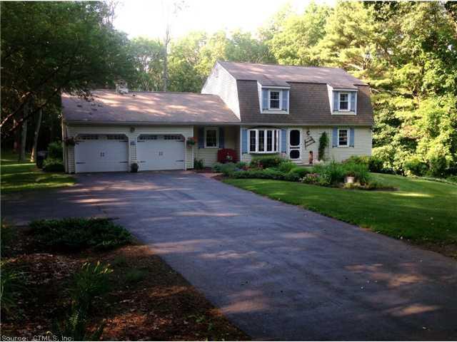 91 Pierce Road Putnam, CT 06260 - Photo 1 of 1 a front view of a house with a garden and trees