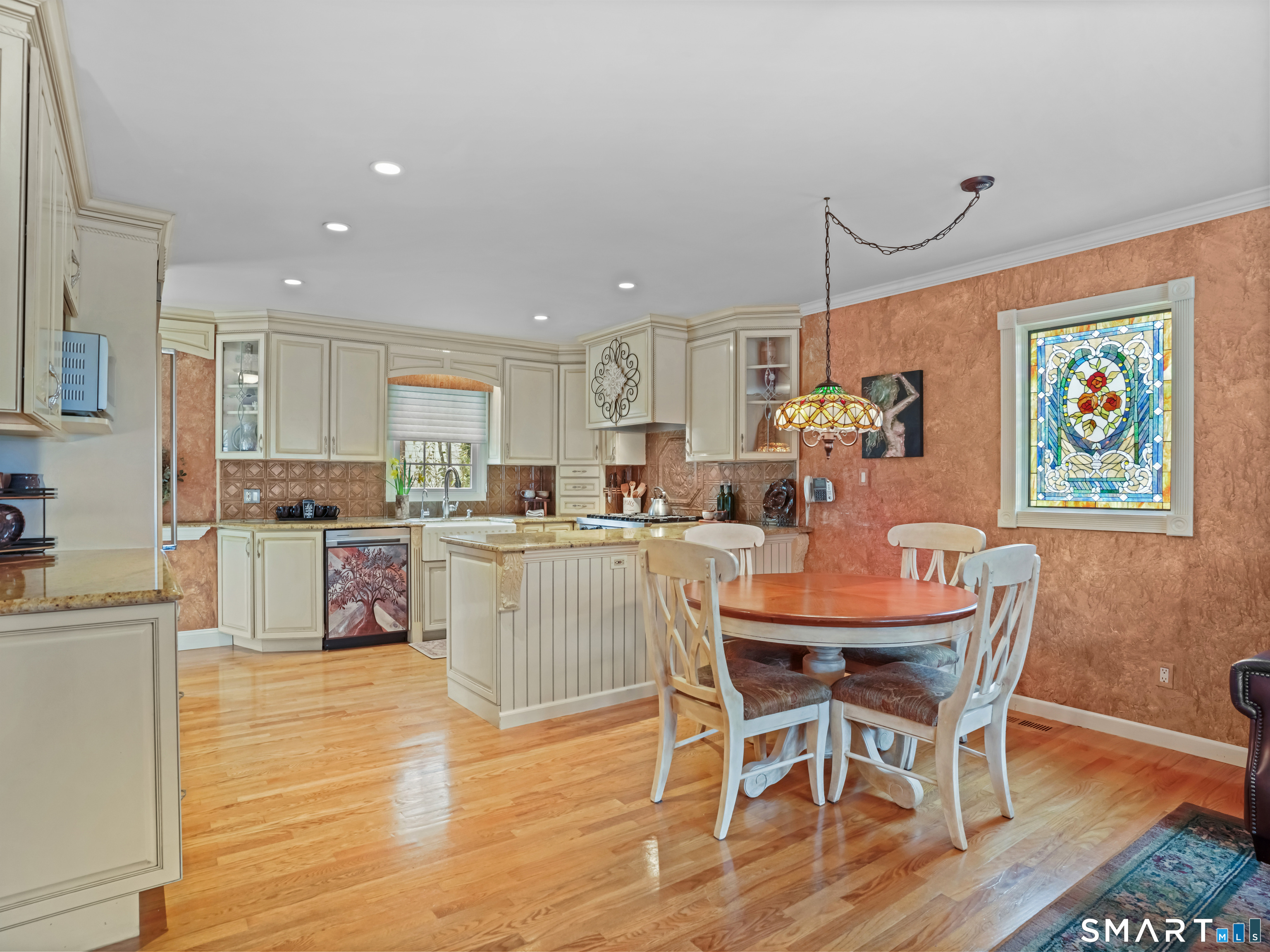 82 Ramapoo Road Ridgefield, CT 06877 - Photo 9 of 40 a kitchen with stainless steel appliances granite countertop a dining table chairs and view living room