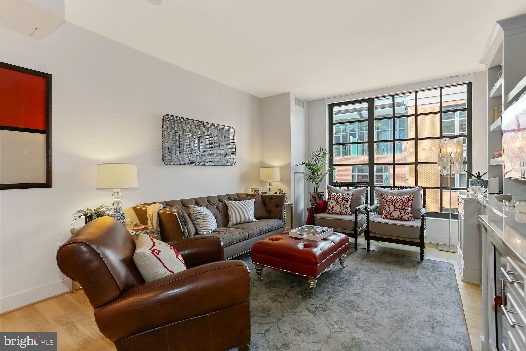 45 Sutton Square Southwest, Unit 1119 Washington, DC 20024 - Photo 1 of 48 a living room with furniture and a large window