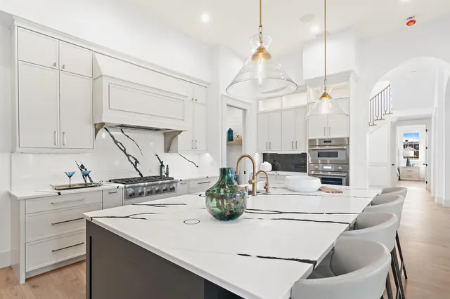 a kitchen with appliances a sink and cabinets