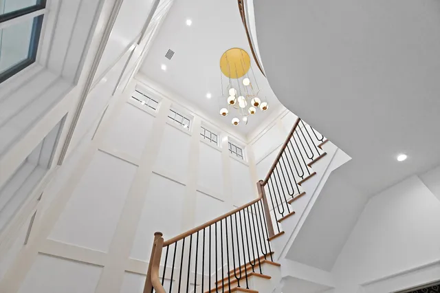 a bathroom with a toilet sink vanity tub and mirror