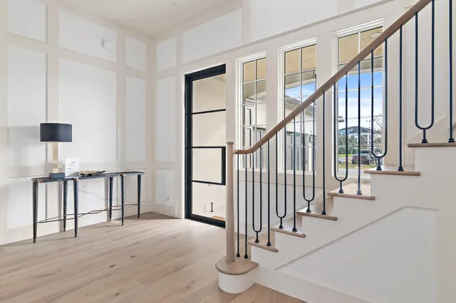 a view of entryway with wooden floor and stairs