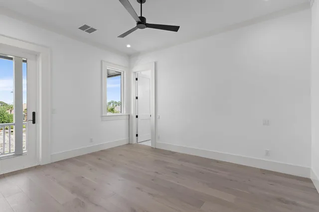 an aerial view of a house with a yard from a lake view